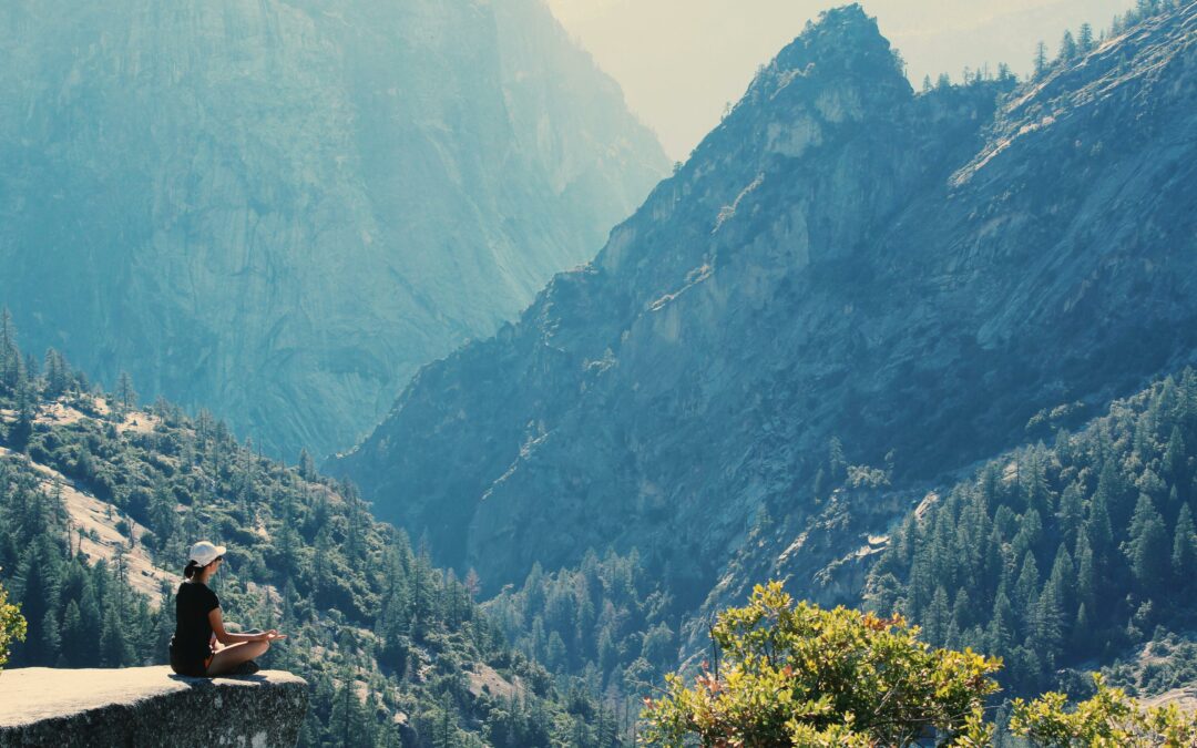 Sitting on a cliff overlooking the valley and mountains